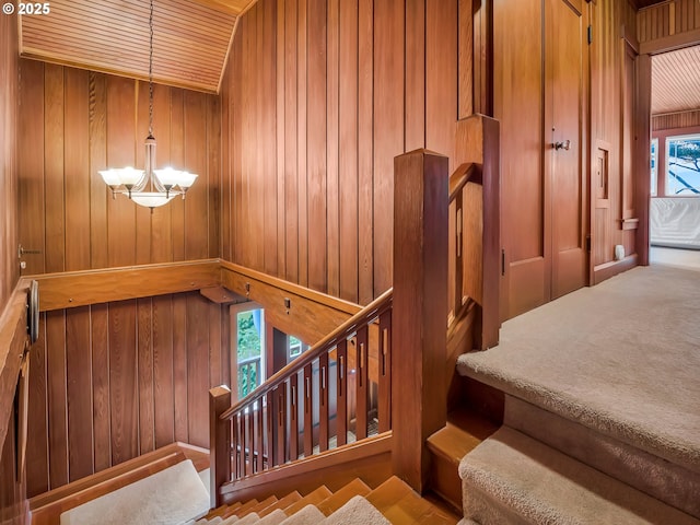 1021 S Prom, Seaside, OR 97138 - staircase featuring wooden walls and a chandelier