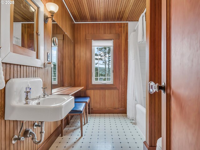 1021 S Prom, Seaside, OR 97138 - full bath featuring wooden walls, a sink, wood ceiling, shower / bath combo with shower curtain, and tile patterned floors