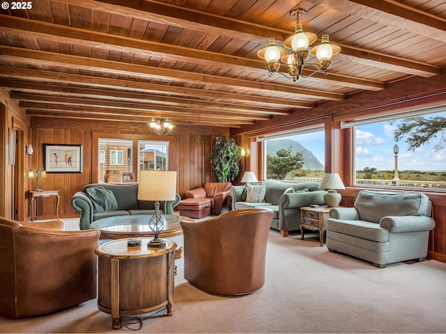 1021 S Prom, Seaside, OR 97138 - carpeted living area with a chandelier, wooden ceiling with exposed beams, plenty of natural light, and wooden walls
