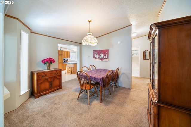 dining space featuring crown molding and light carpet