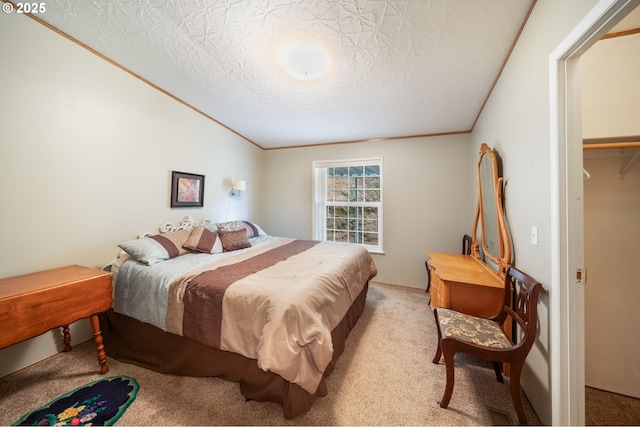 bedroom featuring crown molding, a textured ceiling, and carpet