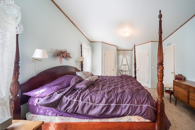 carpeted bedroom featuring two closets and ornamental molding