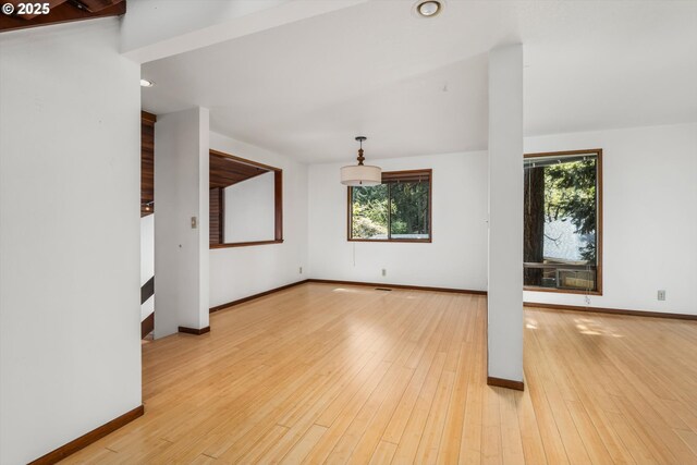 unfurnished living room with baseboards, recessed lighting, and wood finished floors