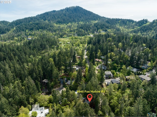 bird's eye view with a mountain view and a wooded view