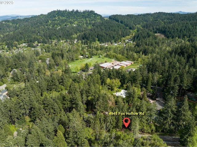 bird's eye view featuring a mountain view and a wooded view