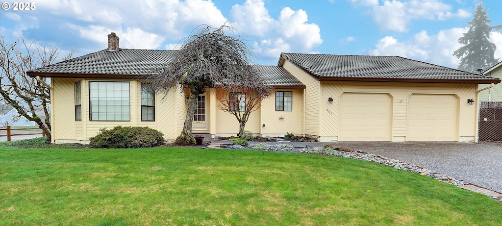 view of front facade featuring a front lawn and a garage