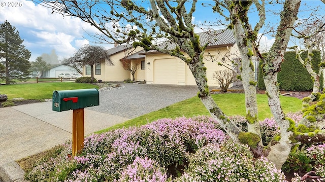 view of front of home featuring a front yard and a garage