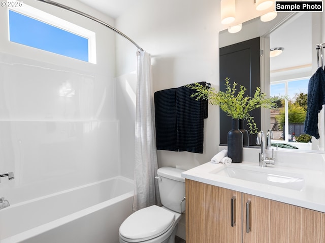 full bathroom with a healthy amount of sunlight, vanity, toilet, and shower / tub combo with curtain
