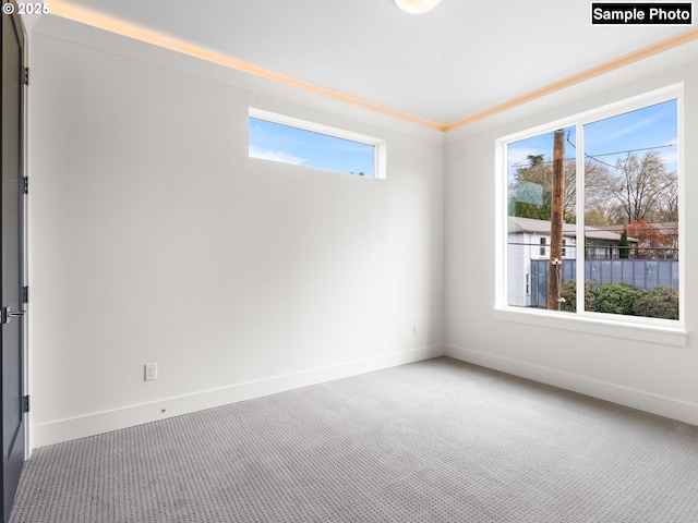 empty room with baseboards and carpet flooring