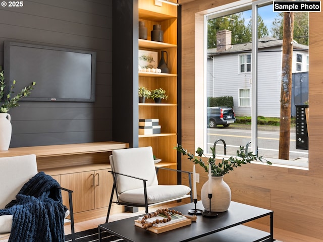 sitting room featuring wood walls