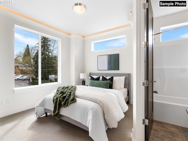 bedroom with baseboards, multiple windows, and dark carpet