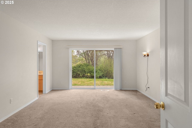 empty room featuring baseboards, carpet flooring, and a textured ceiling