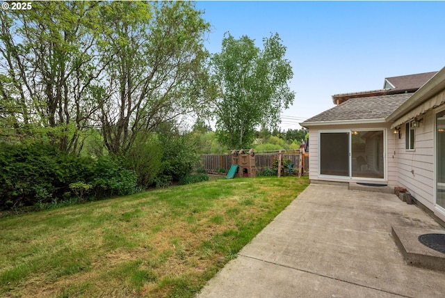 view of yard with a playground, a patio, and fence