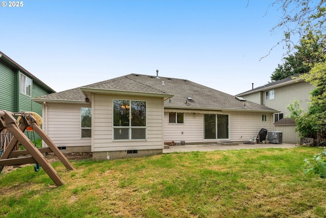 rear view of house featuring a yard, a patio, roof with shingles, and central AC unit