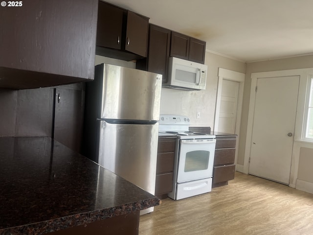103 NW 10th Ave, Milton-Freewater, OR 97862 - kitchen featuring white appliances, light wood-style flooring, crown molding, and dark brown cabinets