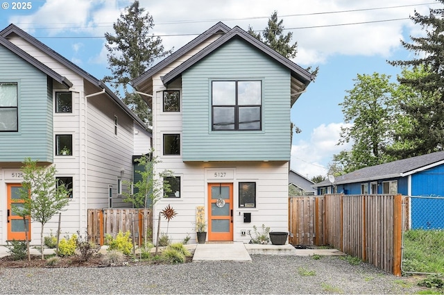 view of front of property featuring fence
