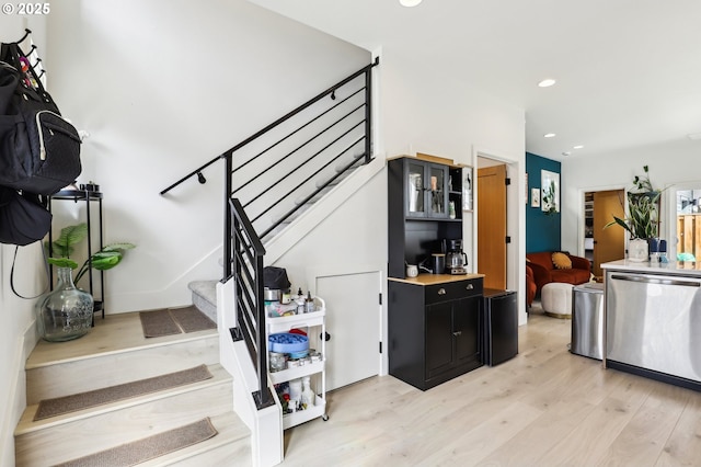 staircase featuring recessed lighting and wood finished floors