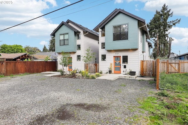 rear view of property featuring a fenced backyard