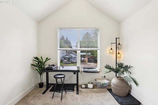 carpeted office space with baseboards and lofted ceiling