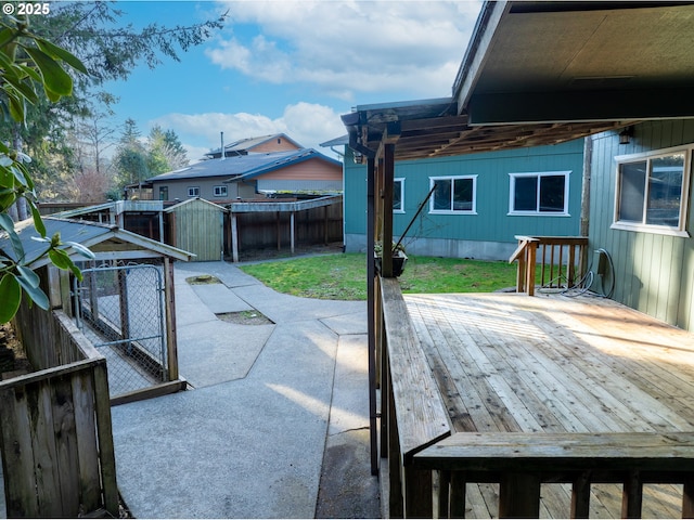 view of patio with a storage unit and a deck