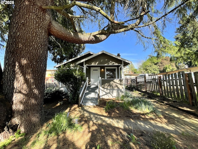 view of front of property with fence and a chimney