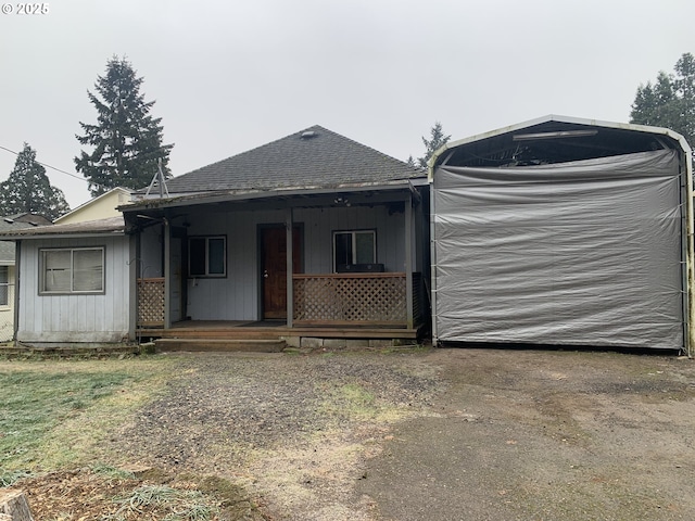 view of front facade featuring covered porch and roof with shingles