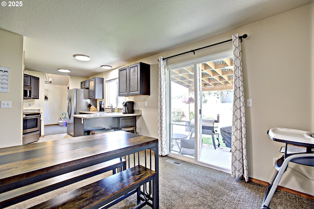 425 Warner St, Oregon City, OR 97045 - dining space with light carpet, a textured ceiling, and baseboards