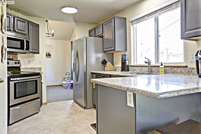 425 Warner St, Oregon City, OR 97045 - kitchen featuring stainless steel appliances, a sink, gray cabinets, light stone counters, and a peninsula