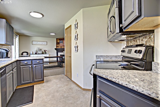 425 Warner St, Oregon City, OR 97045 - kitchen with stainless steel appliances, a fireplace, light carpet, and gray cabinets