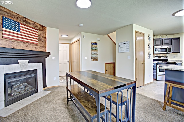 425 Warner St, Oregon City, OR 97045 - dining room with light colored carpet, a textured ceiling, and a fireplace