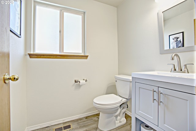 425 Warner St, Oregon City, OR 97045 - bathroom featuring vanity, toilet, baseboards, and wood finished floors