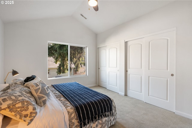 carpeted bedroom featuring a ceiling fan, lofted ceiling, visible vents, and baseboards