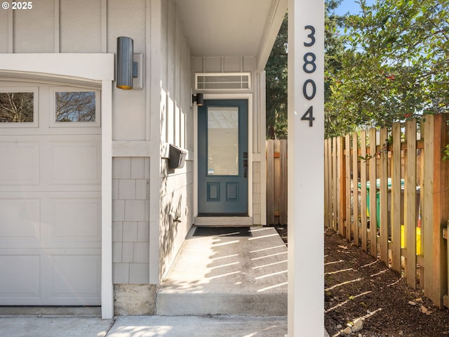 view of exterior entry with fence