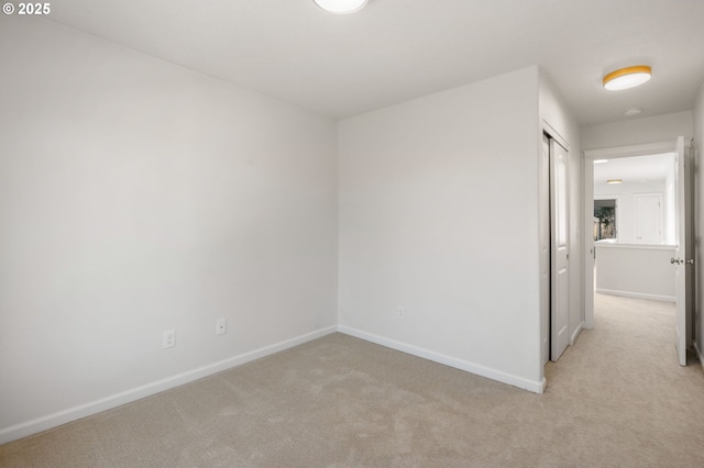 spare room with carpet and baseboards