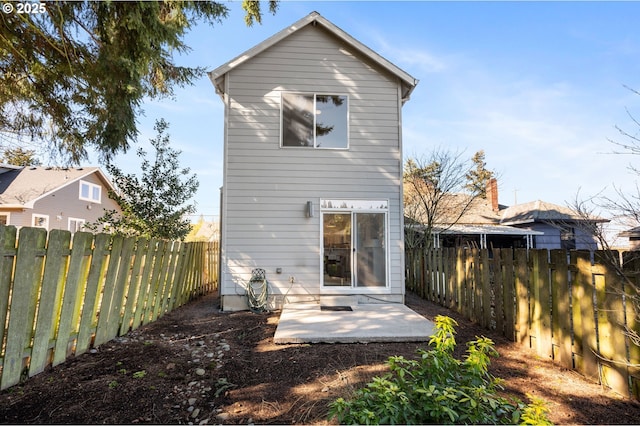 rear view of house featuring a patio area and a fenced backyard