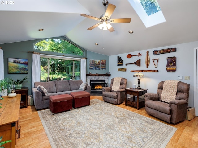 18495 Terry Ave, Lake Oswego, OR 97035 - living area with ceiling fan, wood finished floors, vaulted ceiling with skylight, and a fireplace