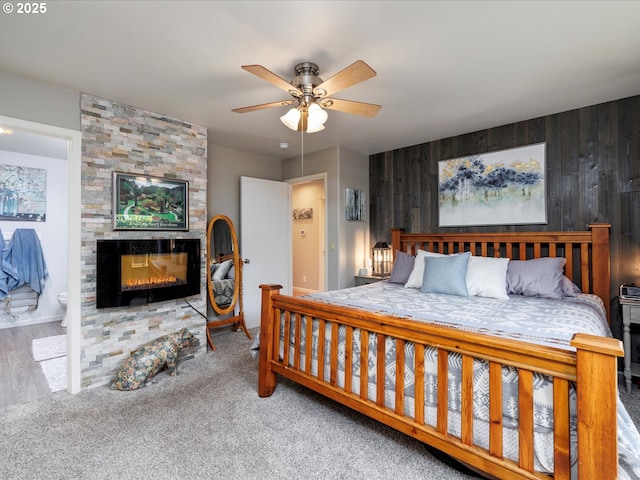 18495 Terry Ave, Lake Oswego, OR 97035 - bedroom featuring wooden walls, a multi sided fireplace, ceiling fan, and carpet floors
