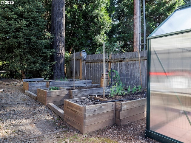 18495 Terry Ave, Lake Oswego, OR 97035 - exterior space featuring an exterior structure, fence, and a vegetable garden