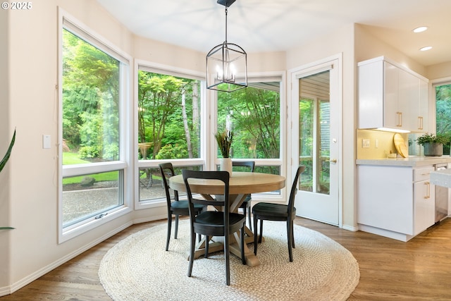 dining room with healthy amount of natural light, a chandelier, baseboards, and recessed lighting