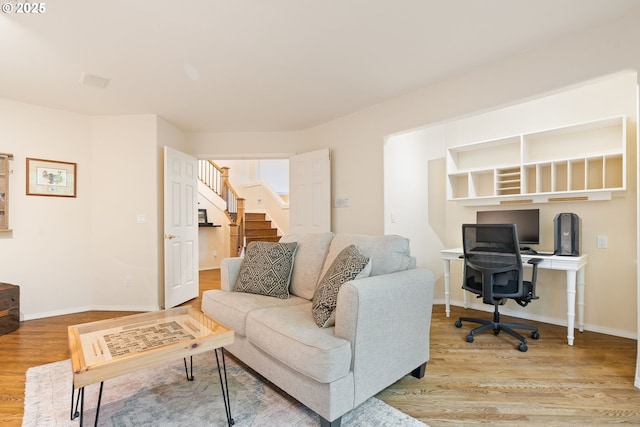 9030 SW Lancelot Ln, Portland, OR 97219 - living room featuring wood finished floors, an office area, and baseboards