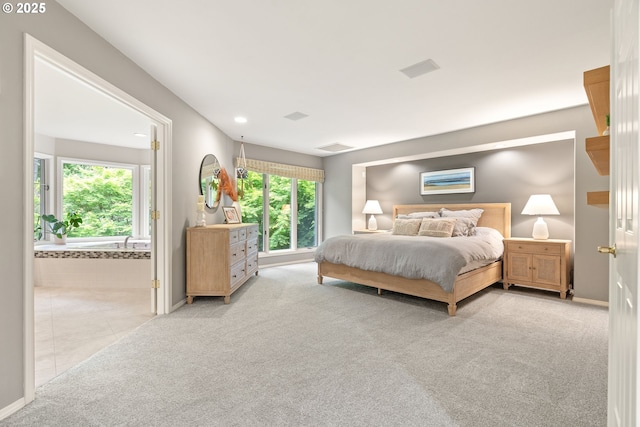 bedroom with light carpet, baseboards, ensuite bath, and recessed lighting