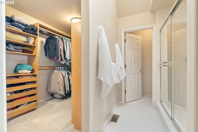 9030 SW Lancelot Ln, Portland, OR 97219 - full bathroom with a walk in closet, a stall shower, and tile patterned floors