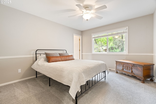 carpeted bedroom featuring baseboards and a ceiling fan