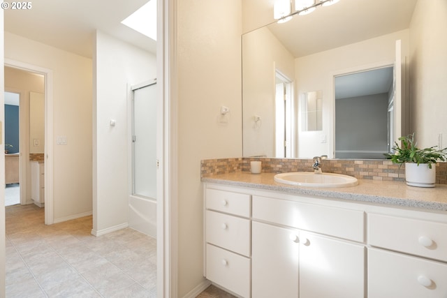 full bathroom featuring decorative backsplash, vanity, enclosed tub / shower combo, tile patterned floors, and baseboards