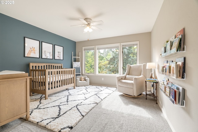 bedroom featuring carpet flooring, baseboards, and a nursery area