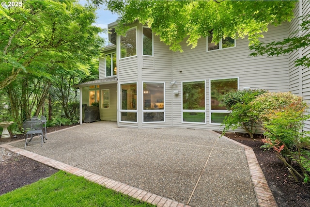 9030 SW Lancelot Ln, Portland, OR 97219 - rear view of house featuring a patio