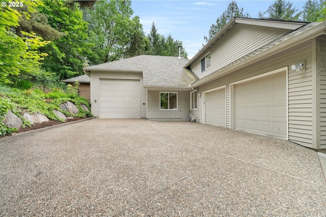 view of front facade featuring a garage, concrete driveway, and a shingled roof