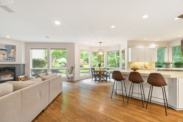 9030 SW Lancelot Ln, Portland, OR 97219 - living room with recessed lighting, healthy amount of natural light, light wood finished floors, and a fireplace