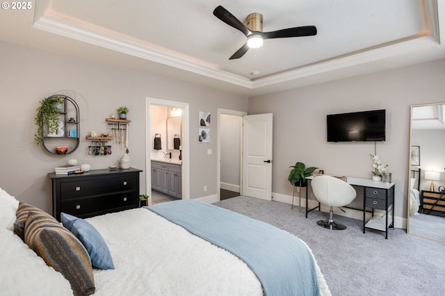 carpeted bedroom with a tray ceiling, ornamental molding, and baseboards