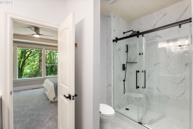 bathroom with toilet and a marble finish shower
